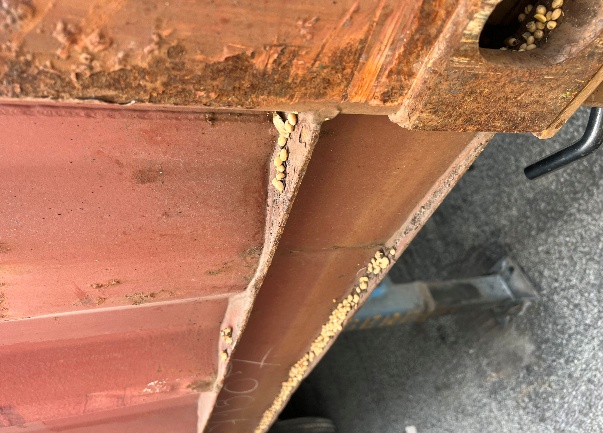 Container underside with debris requiring removal